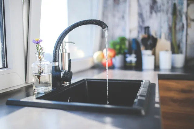 Modern kitchen faucet with running water